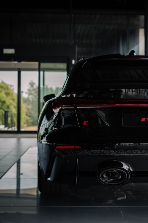 Rear of a black Audi RS sports car in a showroom